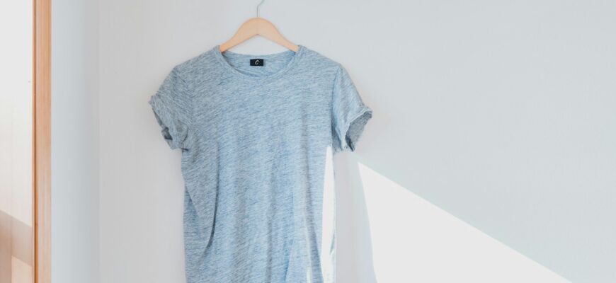 hanged grey shirt on white wall